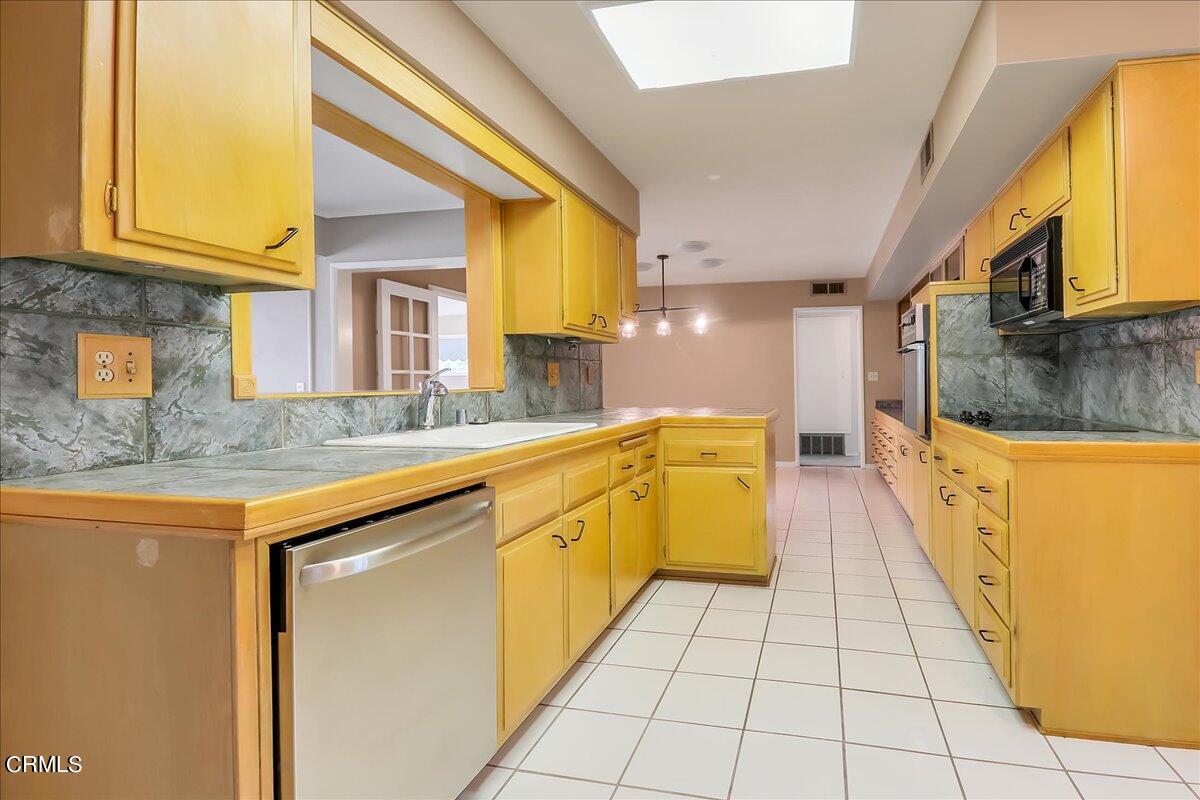 26204 Ridgemoor Road Menifee, CA 92586 - Photo 9 of 35 a large kitchen with stainless steel appliances granite countertop a sink and cabinets