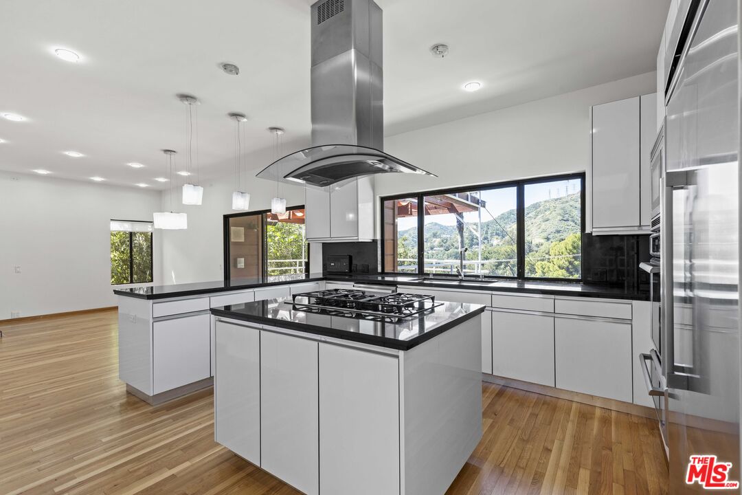 3275 Buckingham Road Glendale, CA 91206 - Photo 16 of 33 a kitchen with stainless steel appliances granite countertop a stove and a refrigerator