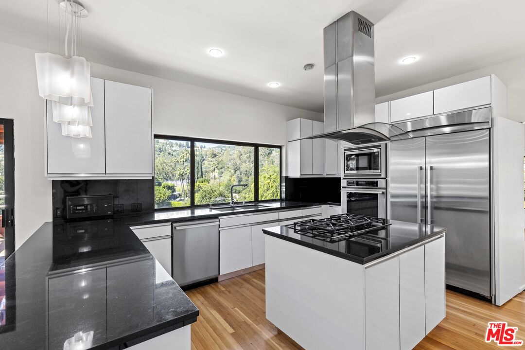 3275 Buckingham Road Glendale, CA 91206 - Photo 17 of 33 a kitchen with a stove a sink and a refrigerator