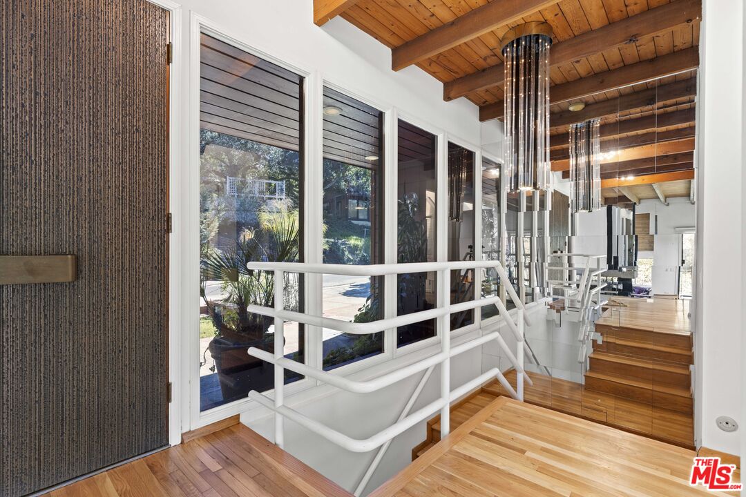 3275 Buckingham Road Glendale, CA 91206 - Photo 8 of 33 a view of a balcony with chairs and floor to ceiling window