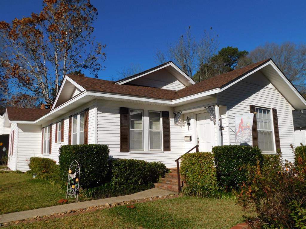 View of side of property with a lawn