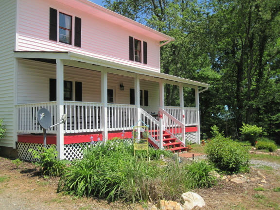 1405 Poor Farm Road Southeast Floyd, VA 24091 - Photo 2 of 46 a view of a house with a yard and balcony