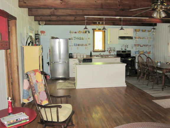 1405 Poor Farm Road Southeast Floyd, VA 24091 - Photo 20 of 46 a kitchen with stainless steel appliances a stove a refrigerator and wooden floor