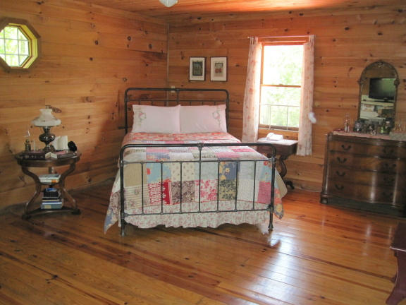 1405 Poor Farm Road Southeast Floyd, VA 24091 - Photo 21 of 46 a bedroom with a bed and a fireplace