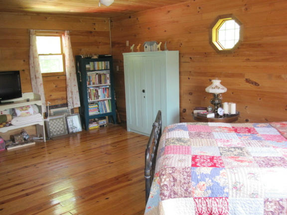 1405 Poor Farm Road Southeast Floyd, VA 24091 - Photo 23 of 46 a bedroom with a bed and wooden floor