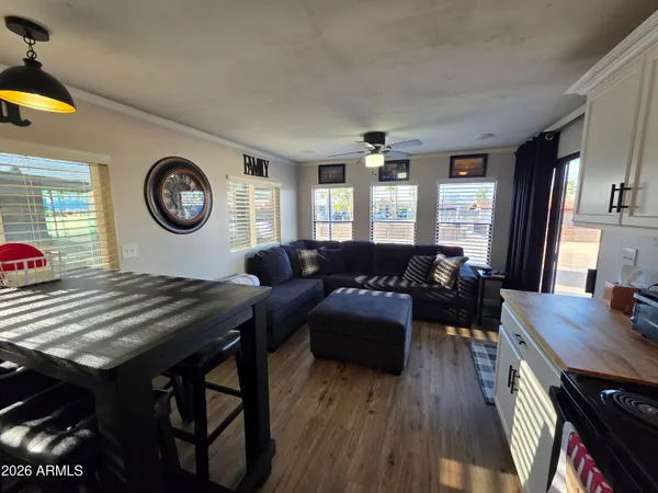 a living room with furniture a clock on wall and a window