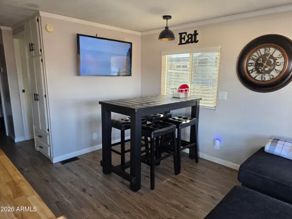 a view of a dining room with furniture wooden floor and a rug