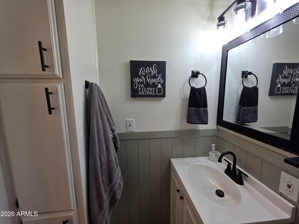a bathroom with a sink mirror and toilet