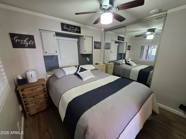 a bedroom with bed and a chandelier