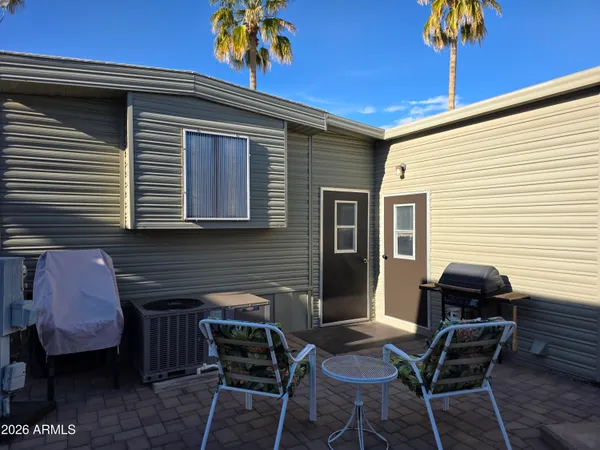 a backyard of a house with table and chairs