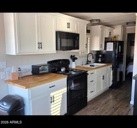 a kitchen with stainless steel appliances a sink stove and cabinets