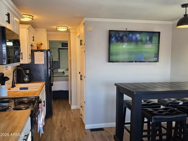 a view of a room with furniture and wooden floor