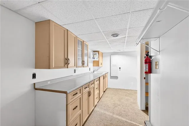 a kitchen with stainless steel appliances granite countertop a sink and a refrigerator