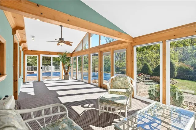 a living room filled with furniture and a floor to ceiling window