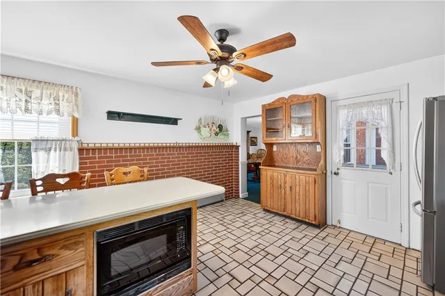 a kitchen with a sink appliances and cabinets