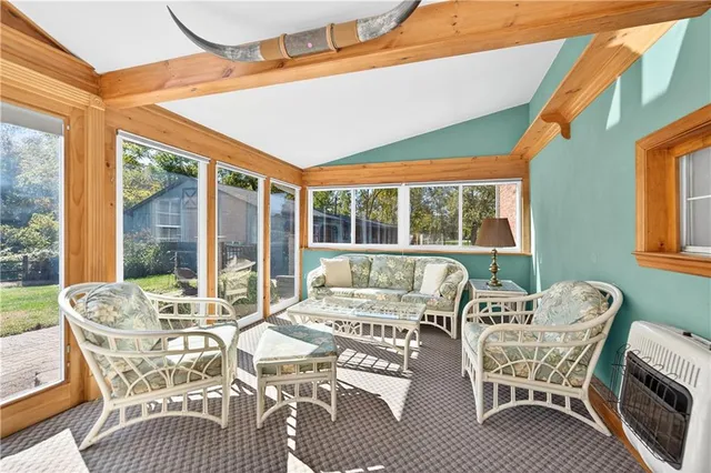 a view of a dining room with furniture large windows and wooden floor