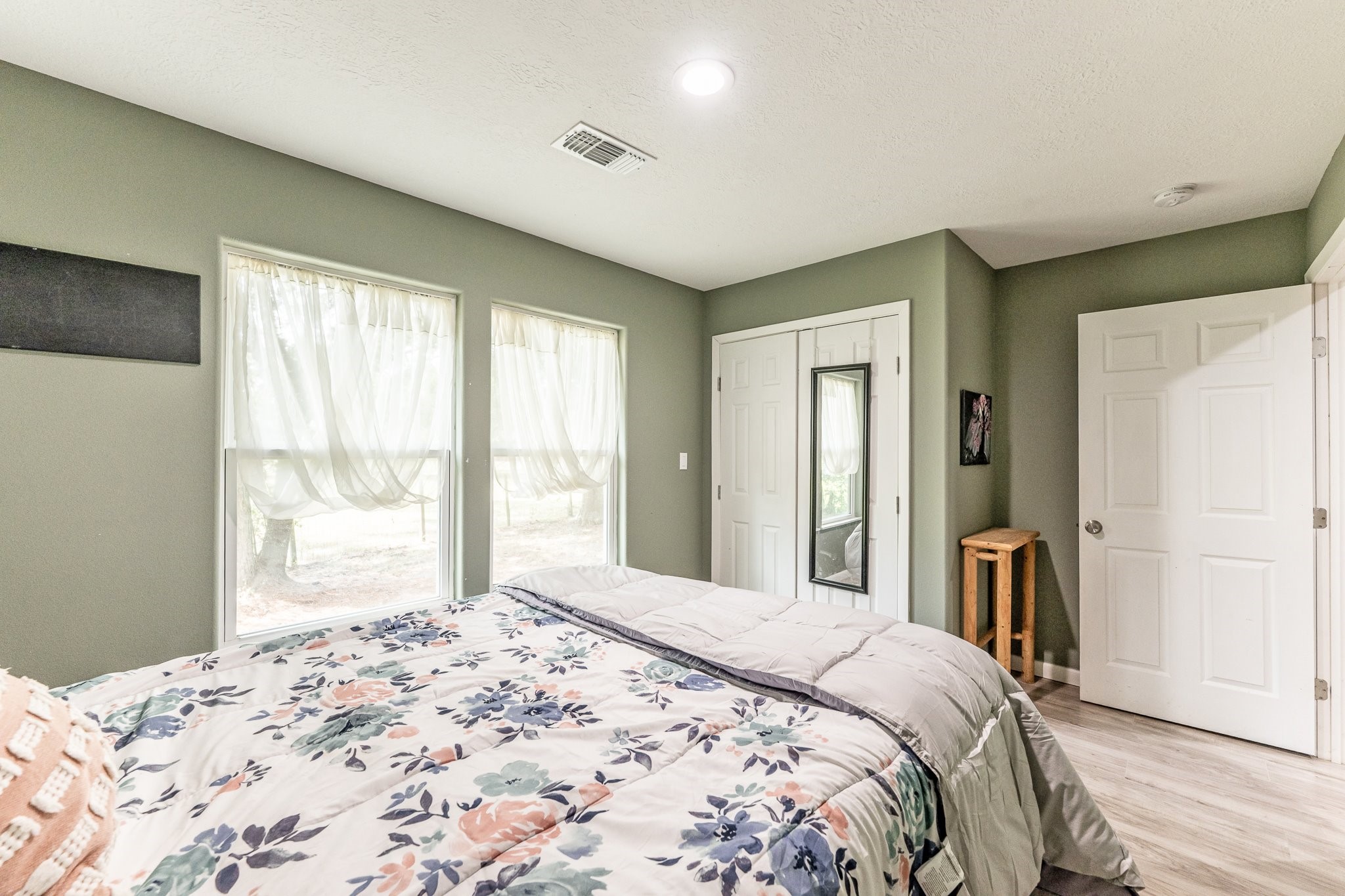 109 Monica Street Trinity, TX 75862 - Photo 20 of 32 a bedroom with a large bed and a large window