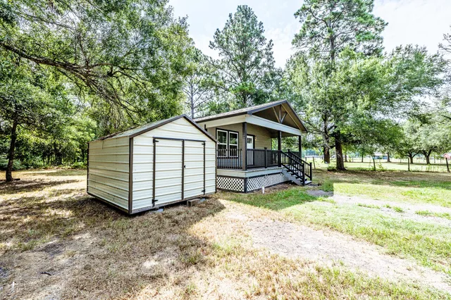 a view of a house with a yard and sitting area