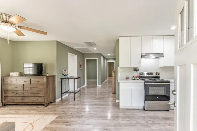 a kitchen with stainless steel appliances kitchen island granite countertop a stove and a refrigerator