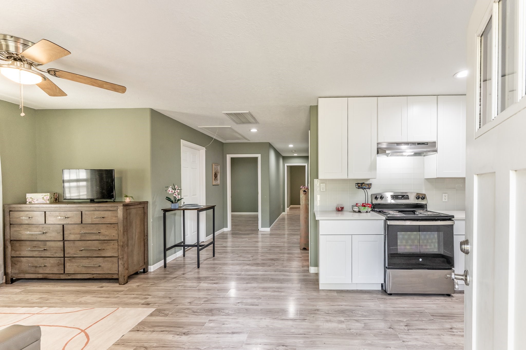 109 Monica Street Trinity, TX 75862 - Photo 3 of 32 a kitchen with stainless steel appliances kitchen island granite countertop a stove and a refrigerator