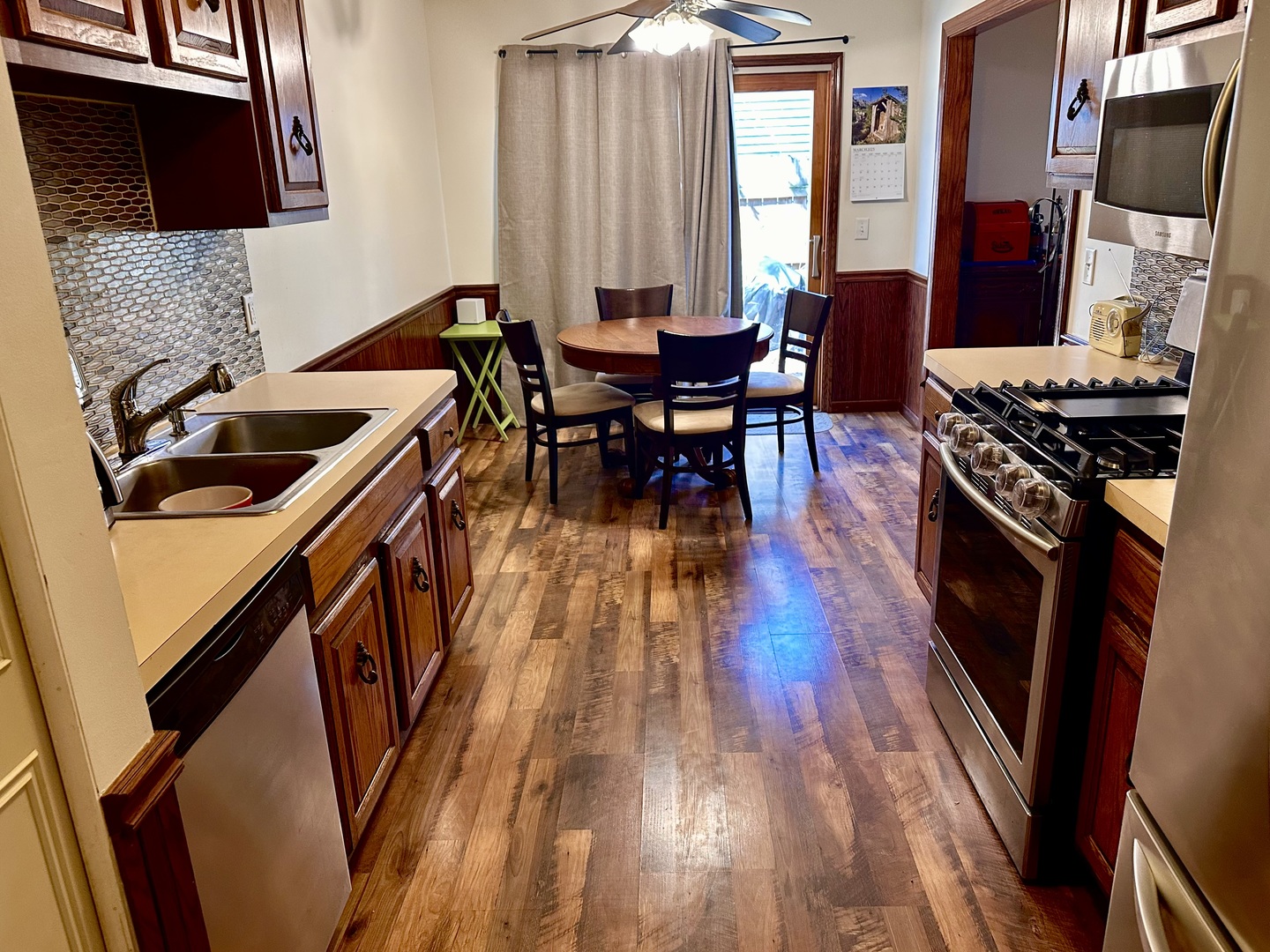 5 Shermead Road Montgomery, IL 60538 - Photo 8 of 27 a kitchen with stainless steel appliances granite countertop a stove top oven a sink dishwasher and wooden floor
