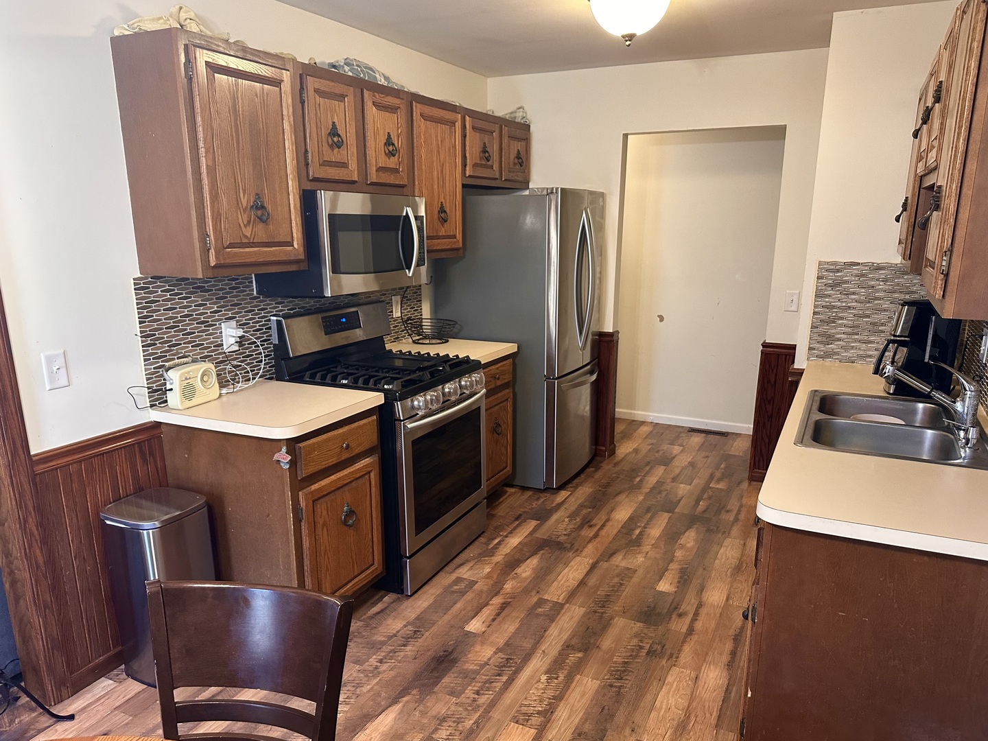 5 Shermead Road Montgomery, IL 60538 - Photo 9 of 27 a kitchen with stainless steel appliances granite countertop a stove refrigerator and microwave