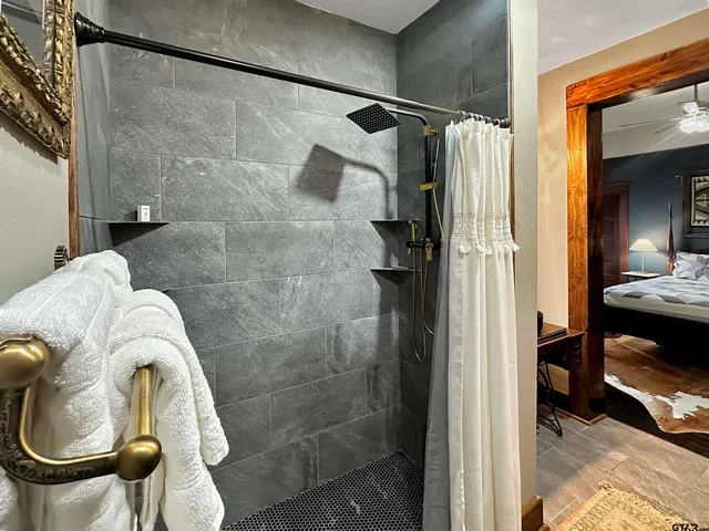 a bed sitting in a bedroom next to a window