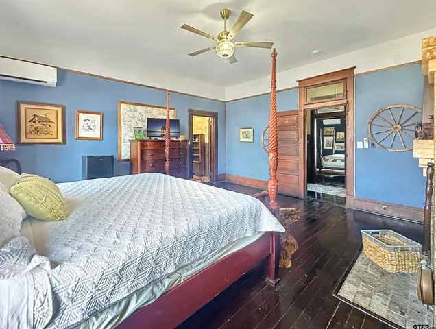 a bedroom with a bed and a chandelier