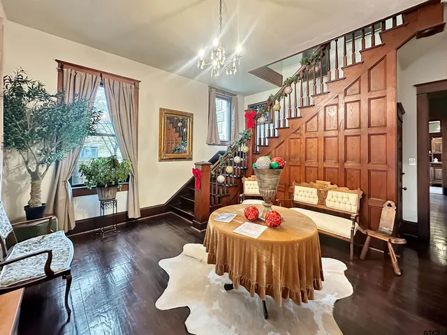 a living room filled with furniture and a chandelier