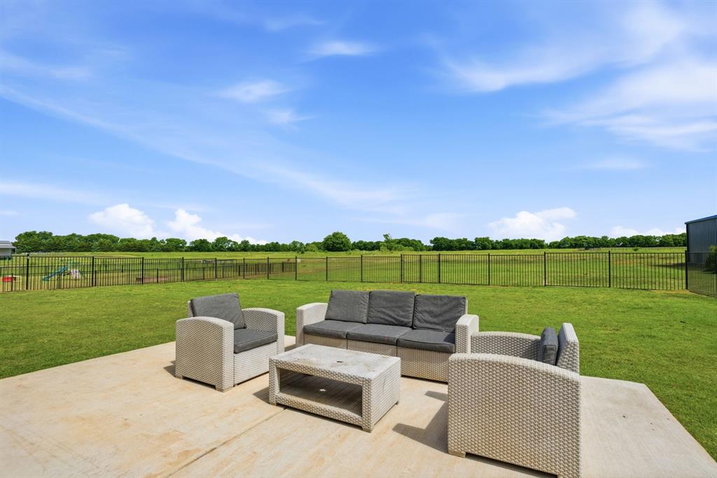 773 Pennell Road Sherman, TX 75090 - Photo 3 of 29 Iron (6 foot) fenced backyard secures kids & pets to play. Sprinkler system covers a portion of the backyard as well.