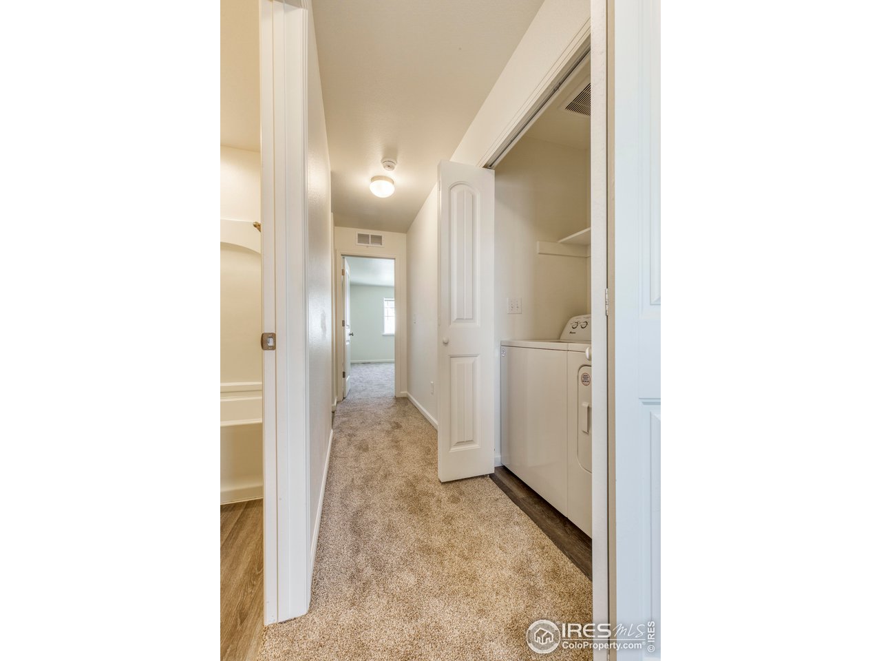 4355 24th Street Road, Unit 3702 Greeley, CO 80634 - Photo 9 of 11 upstairs hallway featuring laundry area