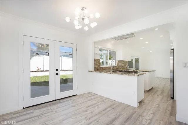 a kitchen with stainless steel appliances granite countertop a stove and a refrigerator