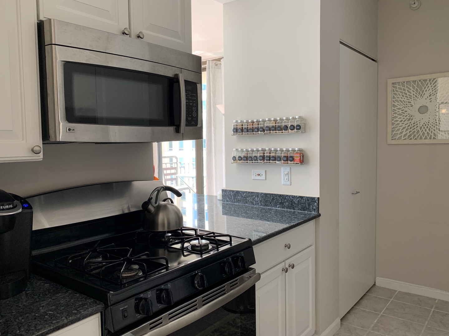 630 North State Street, Unit 2207 Chicago, IL 60654 - Photo 6 of 13 a kitchen with a stove and a microwave