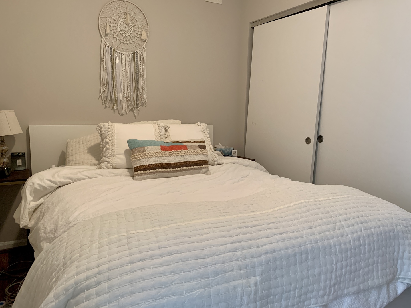 630 North State Street, Unit 2207 Chicago, IL 60654 - Photo 8 of 13 a bedroom with a bed and a mirror