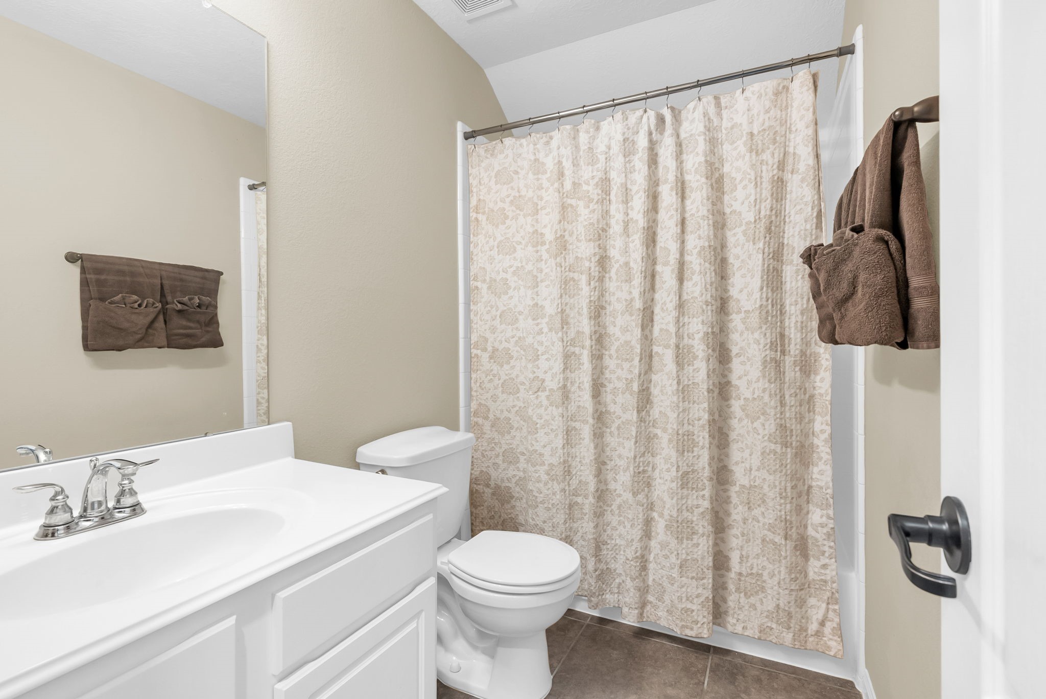 16619 Dover Mills Drive Spring, TX 77379 - Photo 33 of 49 a bathroom with a sink a toilet and shower curtain