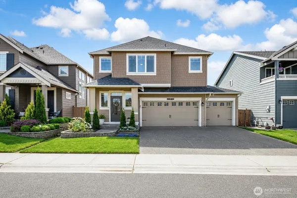 a front view of a house with a yard and garage