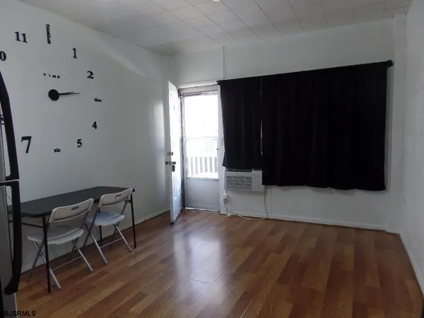 a view of wooden floor and windows in a room