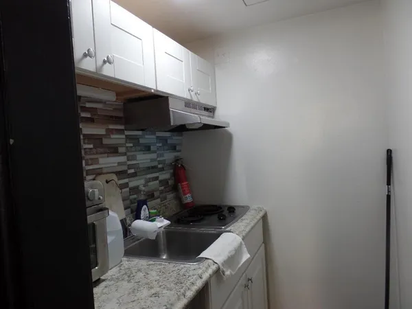 a kitchen with a sink and a stove