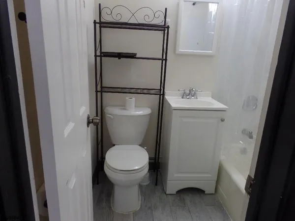 a white toilet sitting next to a bathroom sink