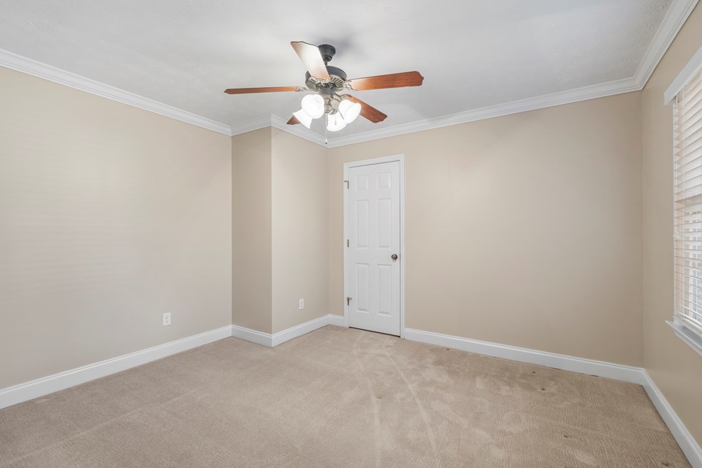 1009 Crosswinds Drive Midland, GA 31820 - Photo 11 of 29 an empty room with a window and a fan