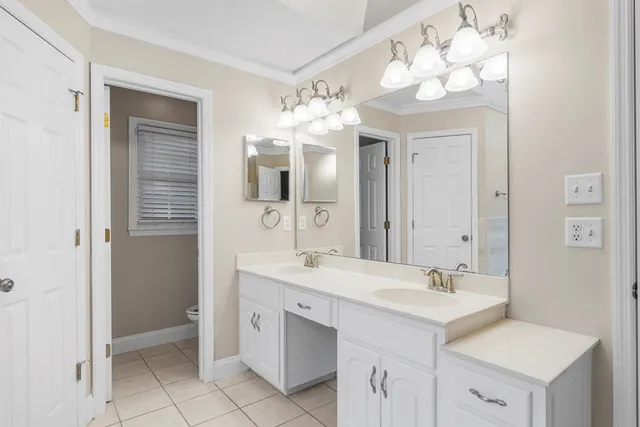 a bathroom with a sink double vanity and a mirror