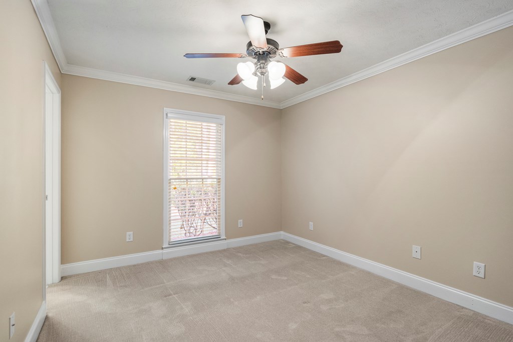 1009 Crosswinds Drive Midland, GA 31820 - Photo 19 of 29 an empty room with a ceiling fan and window