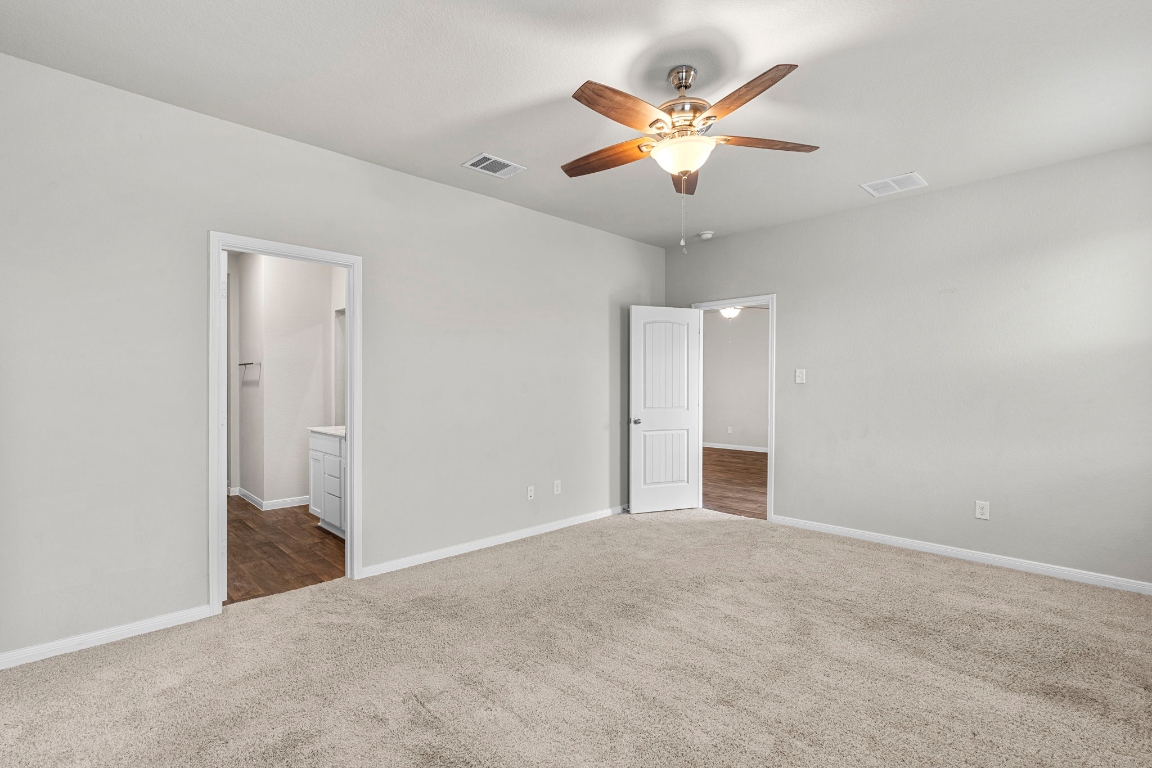 453 Apache Plum Drive Kyle, TX 78640 - Photo 12 of 30 an empty room with closet and fan