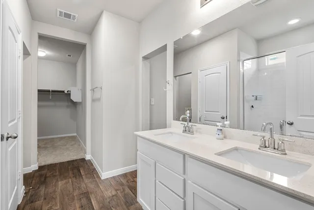 a bathroom with a double vanity sink and a mirror