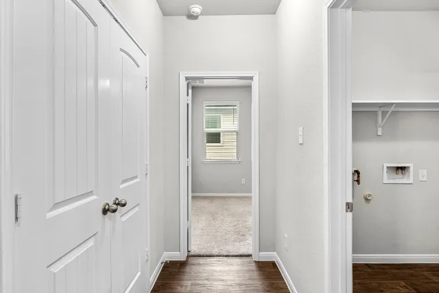 a view of a hallway with wooden floor