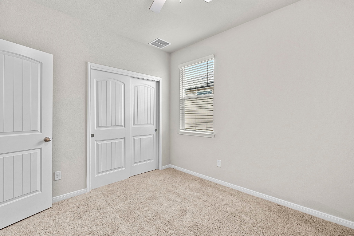 453 Apache Plum Drive Kyle, TX 78640 - Photo 21 of 30 a view of an empty room with a window
