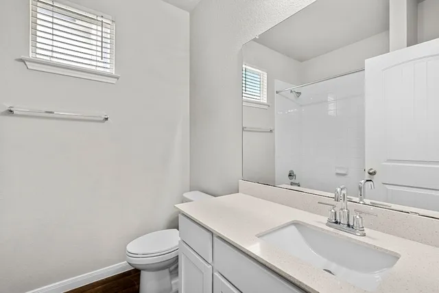 a bathroom with a sink toilet and vanity