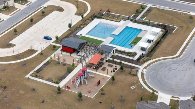 an aerial view of a house with a swimming pool and sitting space