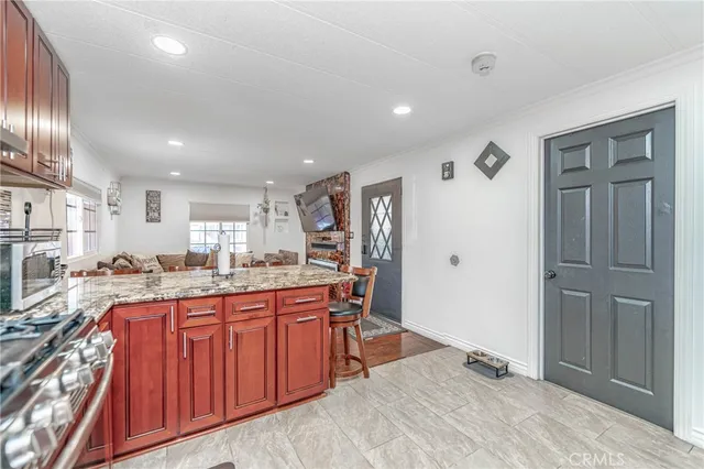 a large kitchen with lots of counter space and painting on the wall