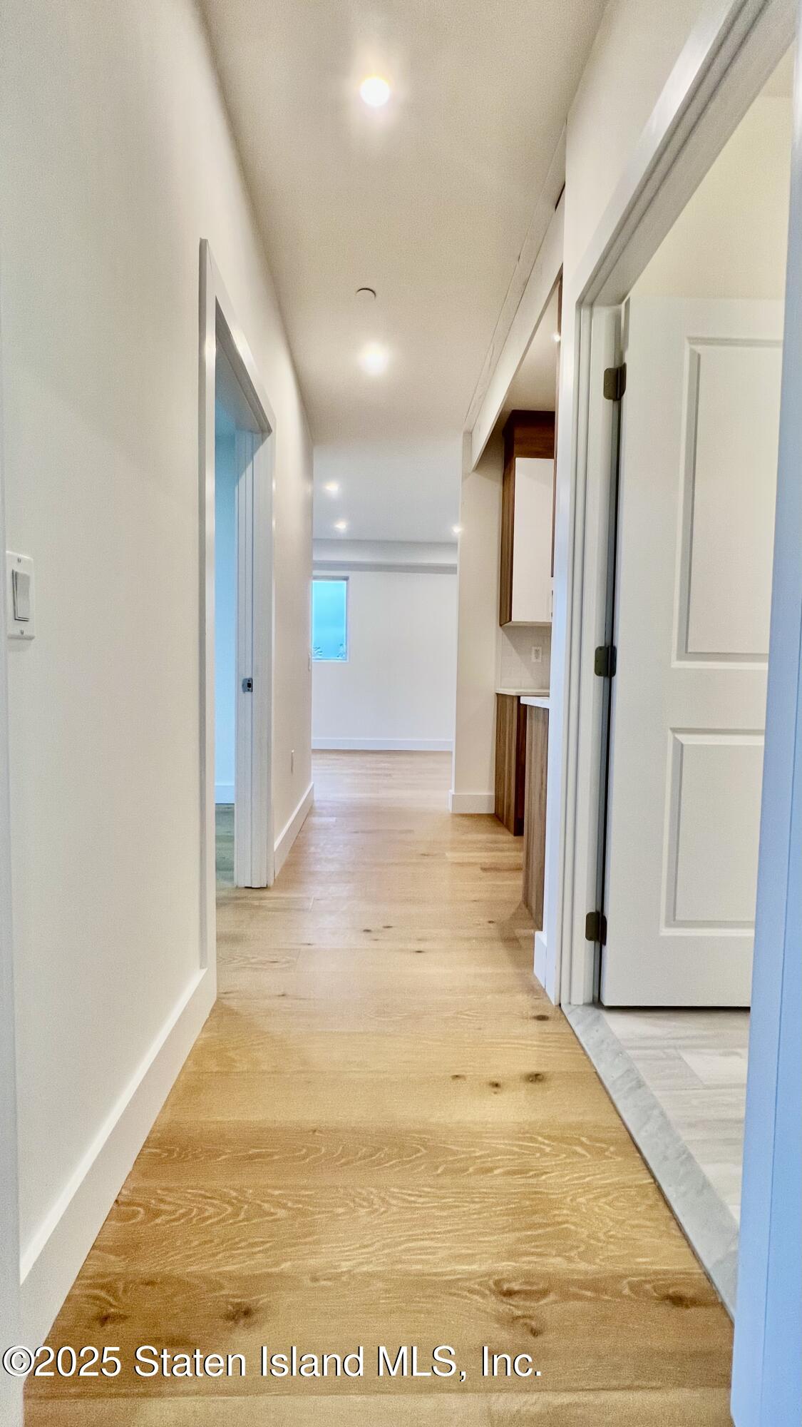 3865 Amboy Road, Unit 2G Staten Island, NY 10308 - Photo 13 of 27 a view of a hallway with wooden shelves